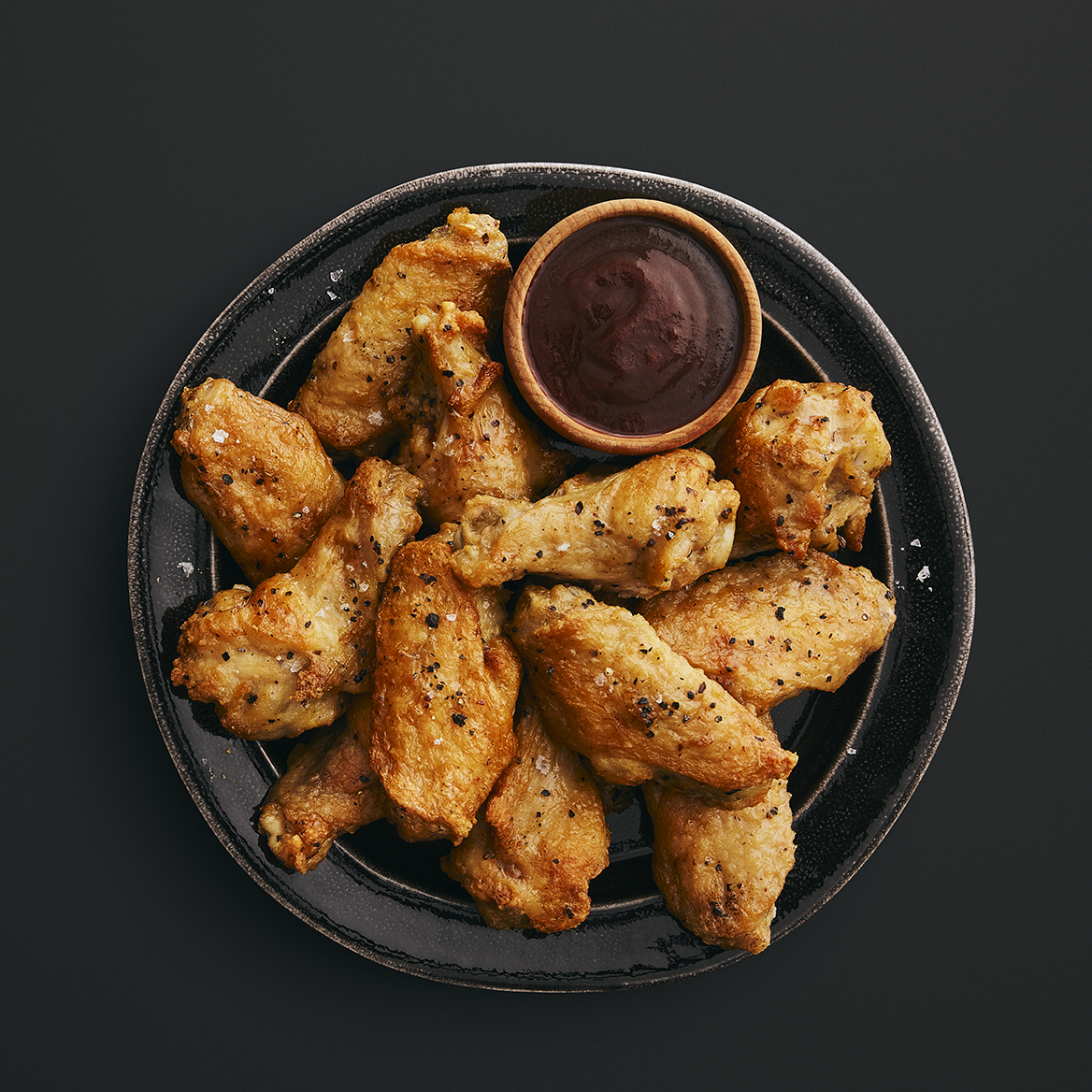 Chicken wings on a plate with bbq sauce